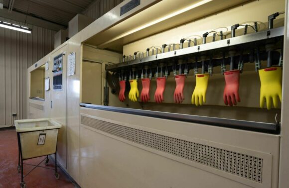 Photograph of rubber gloves mounted into large testing equipment