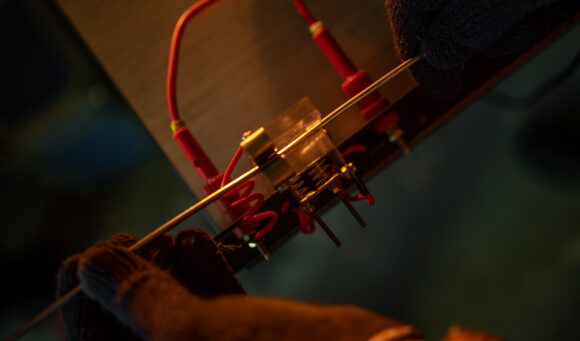 Worker performing adjustments to the horizontal test machine