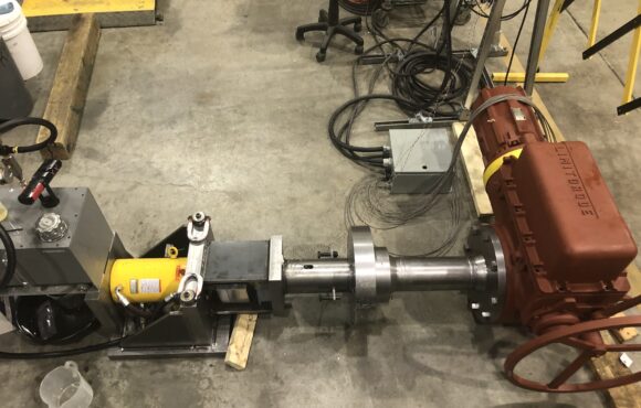 Photograph of machine parts spread on concrete floor