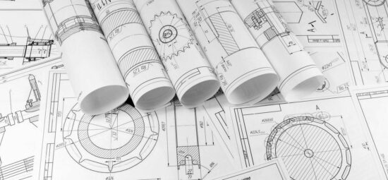 Multiple printed diagrams spread-out across a tabletop