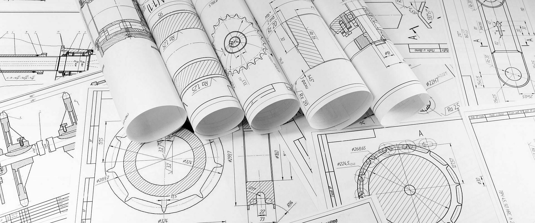 Multiple printed diagrams spread-out across a tabletop