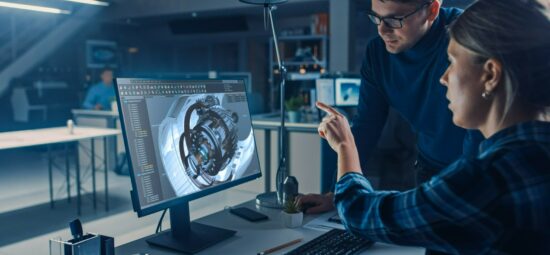 Engineers looking at a design concept on a computer screen