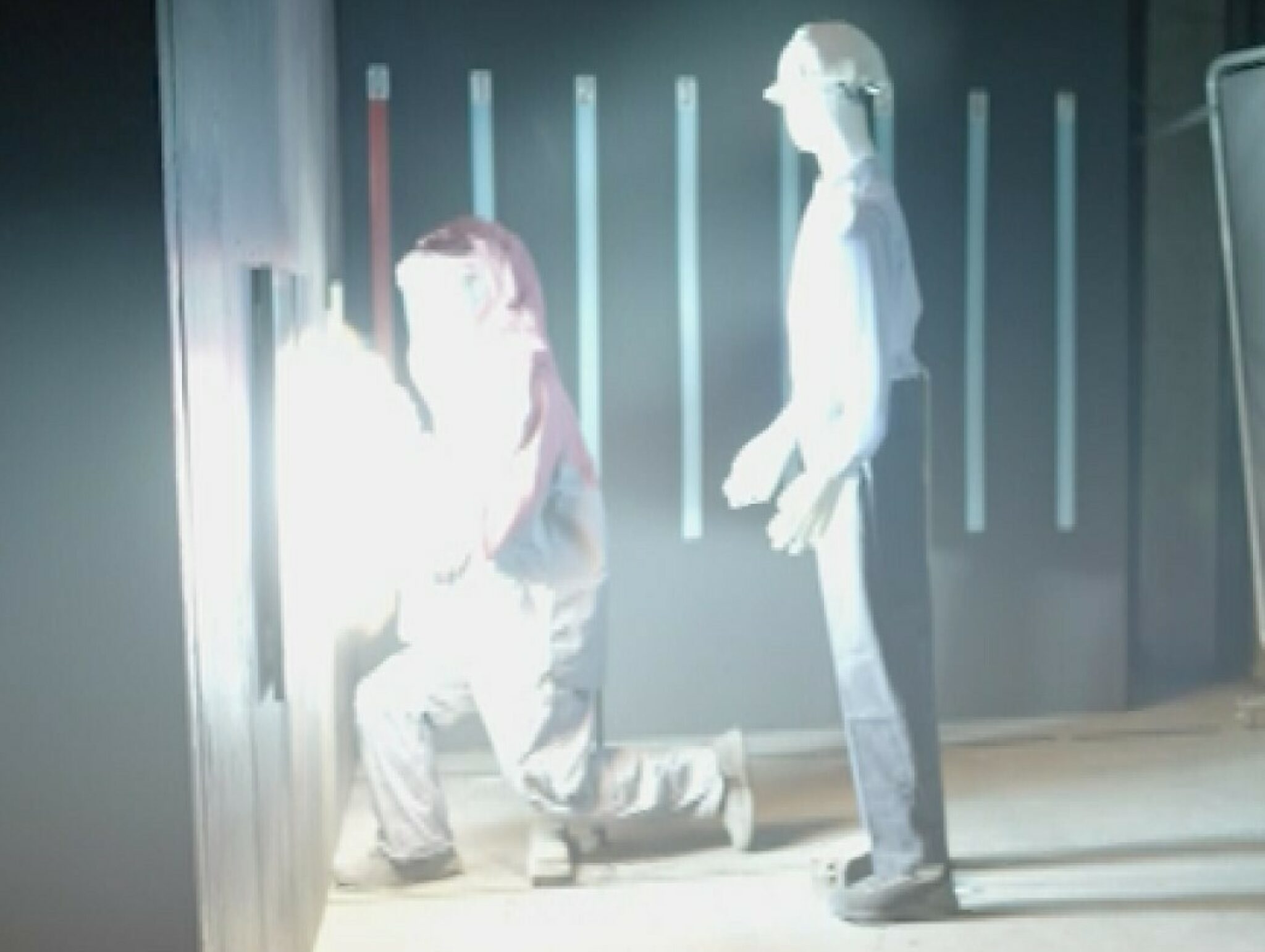 Two testing dummies wearing different protective suits undergoing arc test