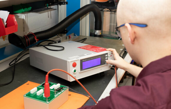 Worker testing a reverse engineered control panel