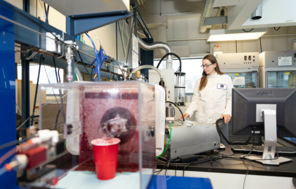 Worker performing tests in Kinectrics particle filtration efficiency lab