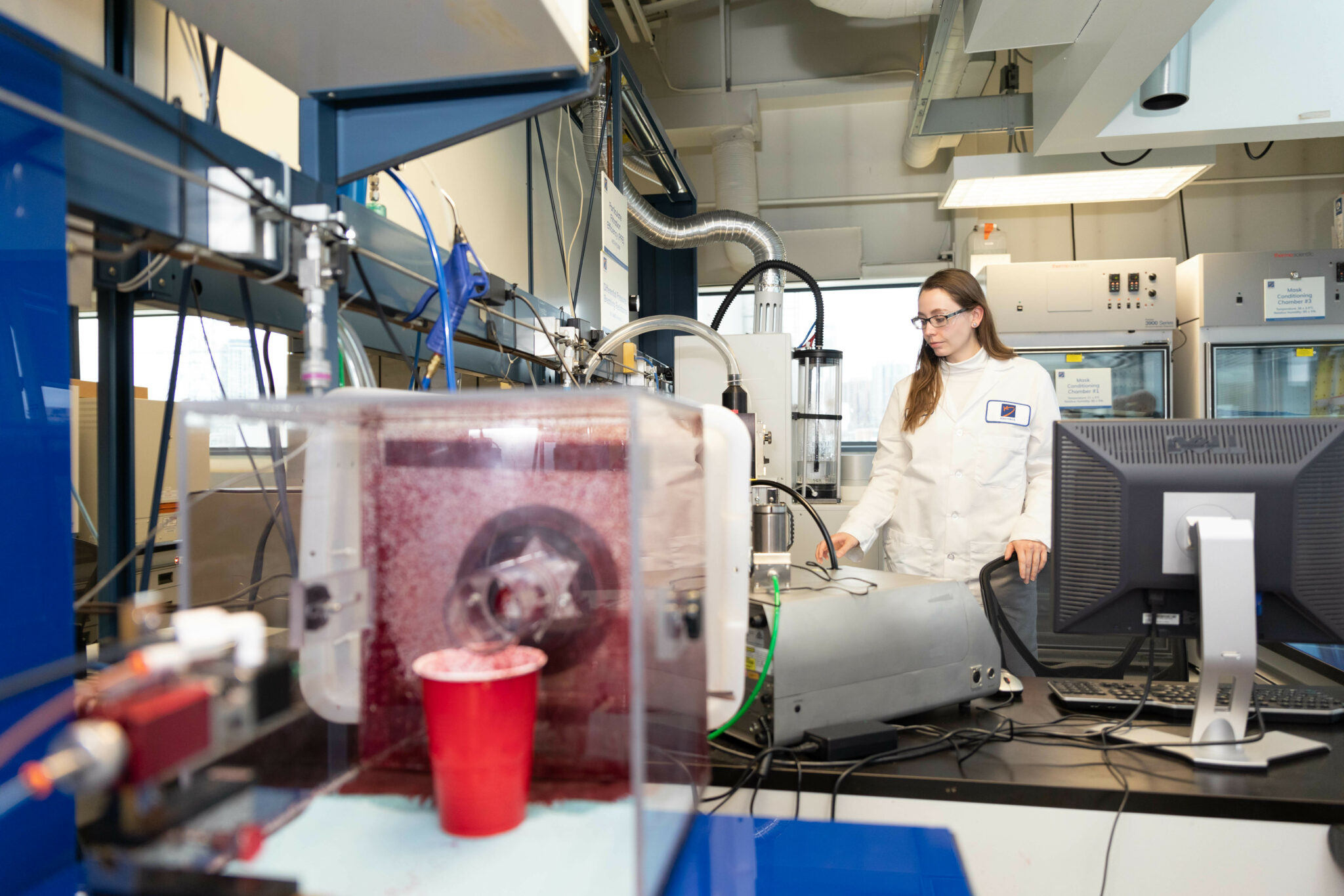 Worker performing tests in Kinectrics particle filtration efficiency lab
