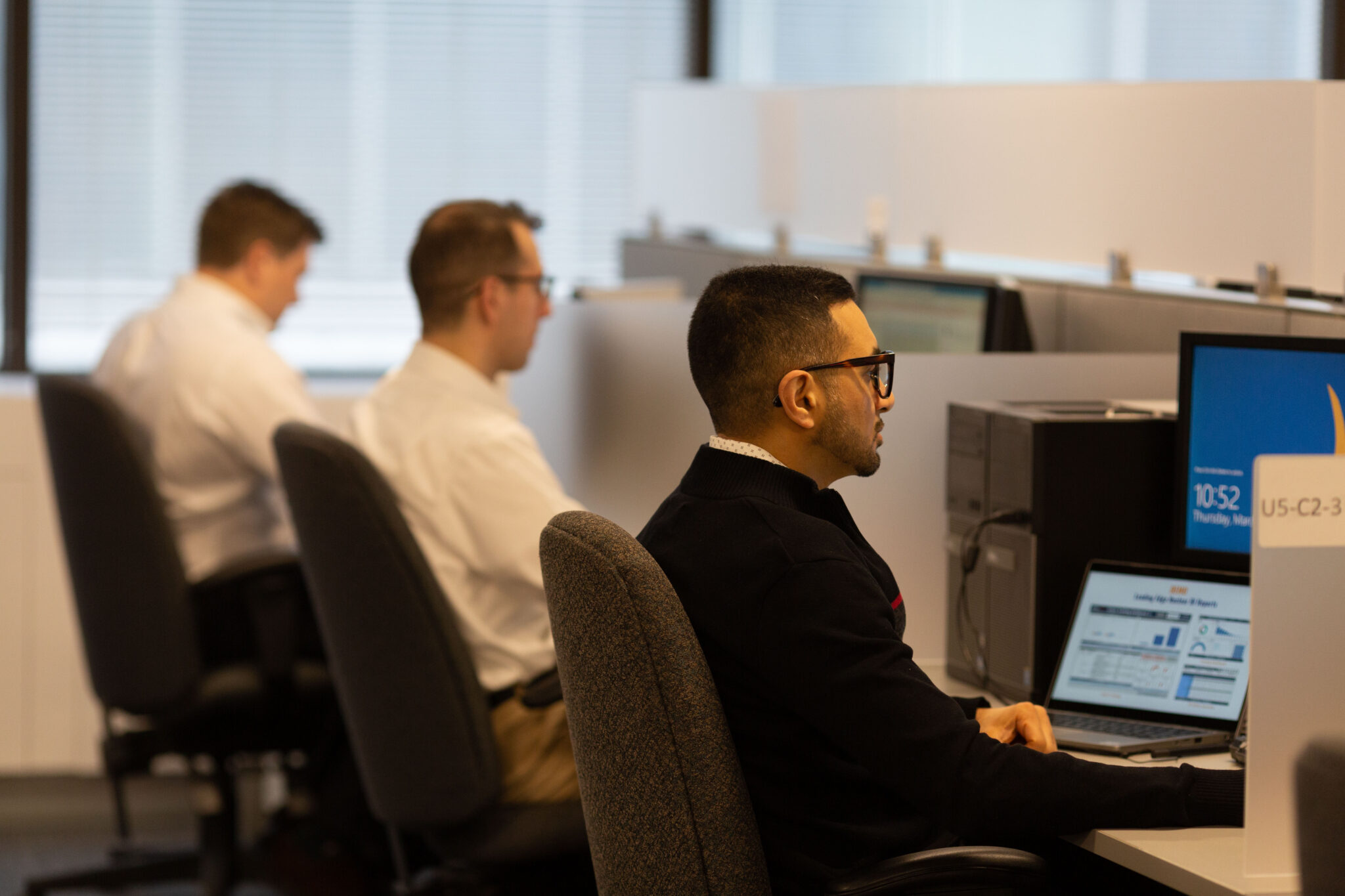 An open office with workers at their stations.