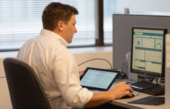 Worker comparing statistics on a computer