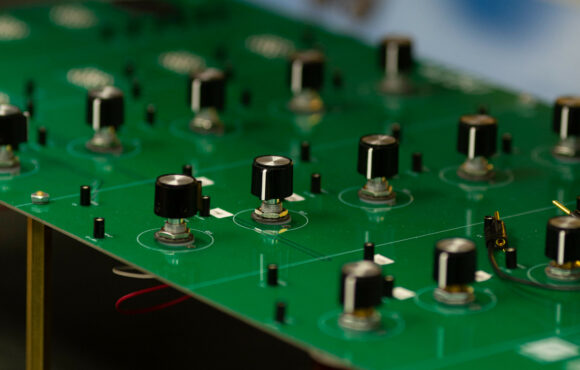 Closeup of a control panel filled with dials that has been reverse engineered