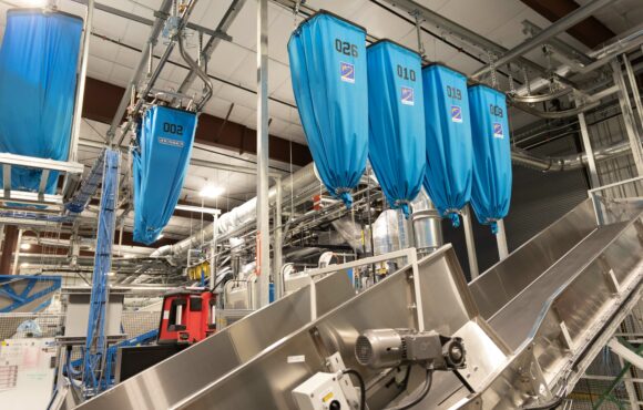 Interior photograph of laundry facility conveyor belts and chutes