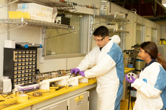 Technicians working on a decontaminated tool