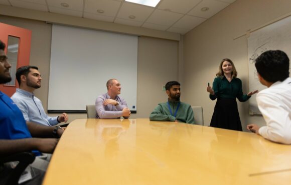 Worker presenting to a team