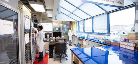 Workers performing tests in Kinectrics' mask testing facility