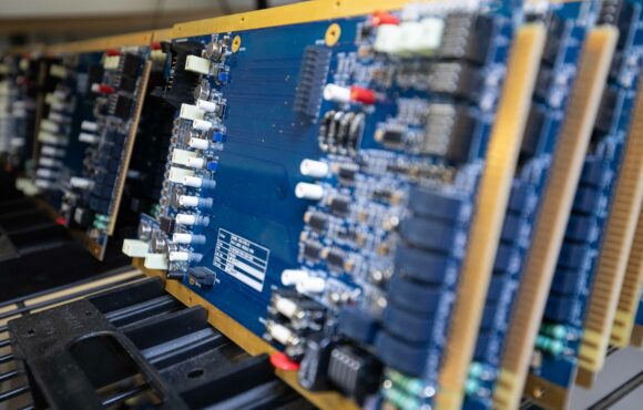 Closeup of rack containing identical assembled machine parts