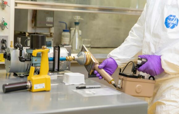 Worker using a measuring device on a machine component