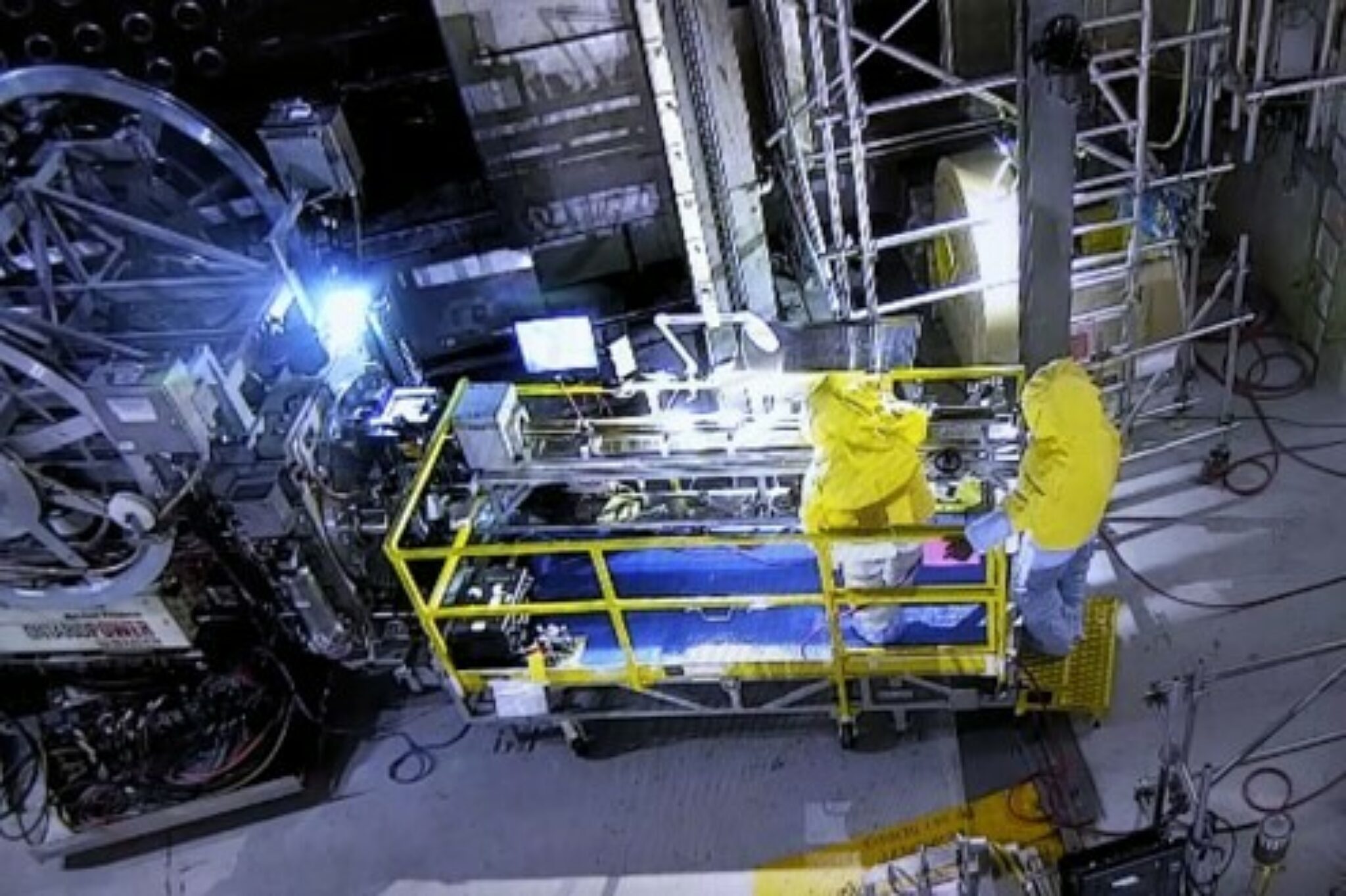 Two CWEST technicians standing on a sample retrieval cart