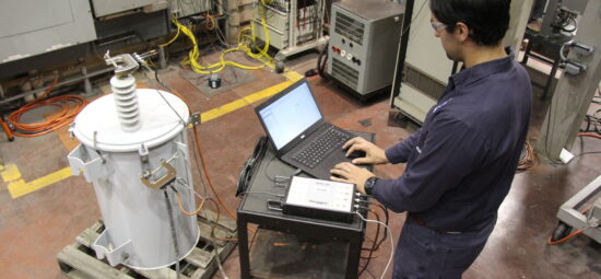 Technologist performing SFRA test on a polemount transformer after short circuit test in high current lab of kinectrics