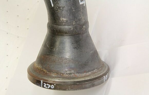 Closeup photograph of a warn and rusting machine part