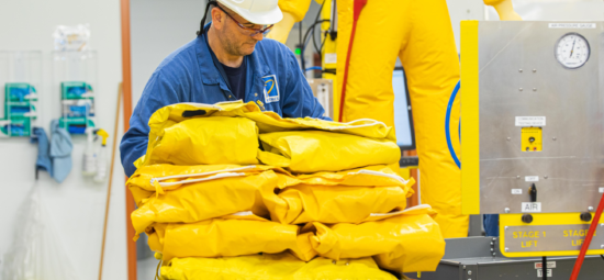Kinectrics worker carrying yellow protective suits